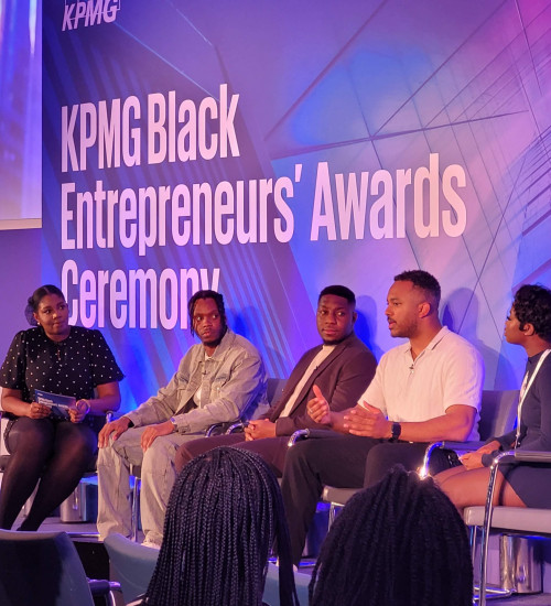 Five people on a speakers panel at KPMG Black Entrepreneurs Awards.