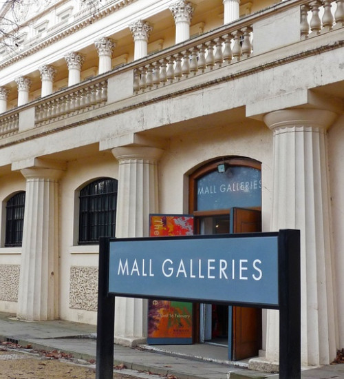 Sign for Mall Galleries with the building entrance in the distance.