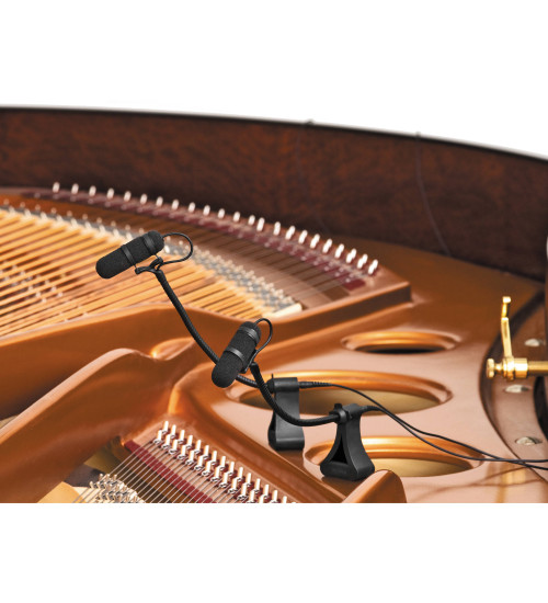 microphones set within an open grand piano.