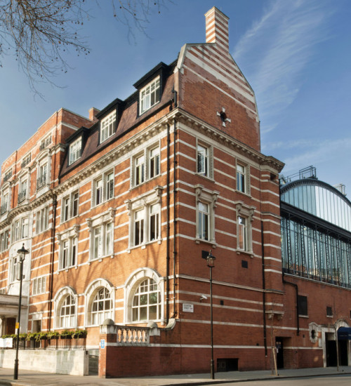 Street photo of a luxury brick building in London.